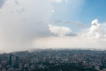 Aerial view of a city with white fluffy clouds in the sky