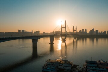 Fototapeta premium Sunset scene of a bridge over the River Severn with silhouette modern buildings