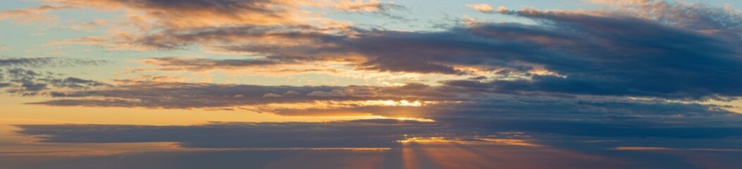 Fototapeta na wymiar golden clouds after sunset on a dark blue sky