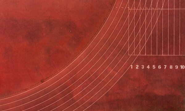 Aerial top view of a brown running track on a sunny day