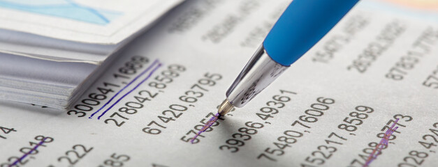Obraz premium Accounting document with pen, money, coins and checking financial chart. Concept of banking, financial report and financial audit.