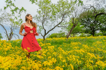 A Lovely Brunette Model Poses In A Field Of Yellow Flowers In A Texas Prarie