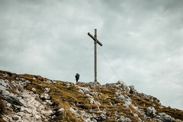 Summit of a rocky Benediktenwand mountain with a big cross on it, Germany