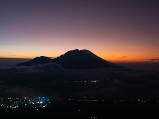 Scenic sunrise above clouds with a mountain volcano view in Bali, Indonesia
