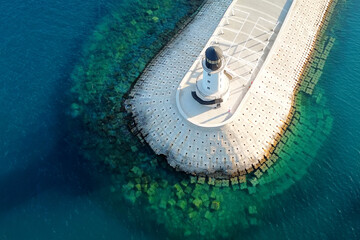 Amazing aerial view of lighthouse and dam on Lustica bay near Tivat, Montenegro on sunny day. - obrazy, fototapety, plakaty