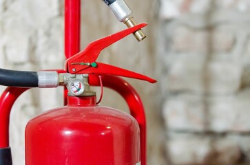 Closeup of a red fire extinguisher on a blurry background