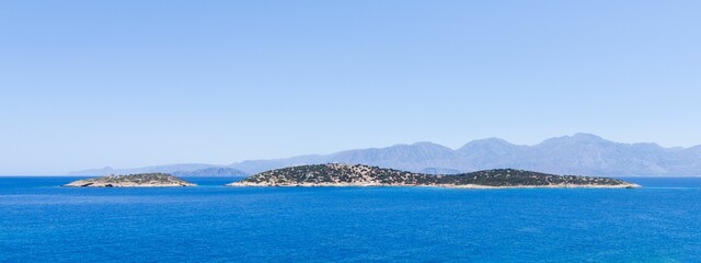 Panoramic shot of an island in the blue sea.