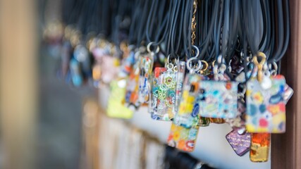 Selective focus shot of handmade glass pendants in sale as souvenirs for tourist