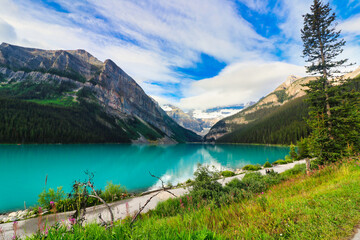 Naklejka premium The Iconic, world famous, picture perfect Lake Louise is framed in the early morning sun near Banff in the Canada rockies