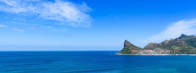 Fototapeten Panoramic shot Hout Bay with rugged coastal mountain and blue sea © Burgie/Wirestock Creators