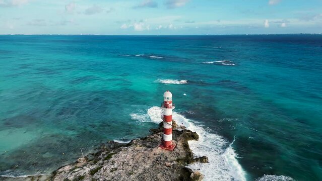 tall Light house in the sea. drone shot view of vintage light house on Caribbean sea coast in Cancun