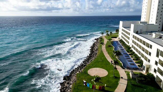 Cancun, Mexico Aerial drone shot showing luxury resorts and blue turquoise beach. People parasailing