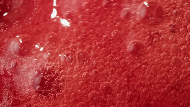 Cooking fruits Jam, Process of making homemade strawberry jam. Red sweet syrup boiling on the stove closeup. Boiling Homemade Strawberry dessert jam macro. 