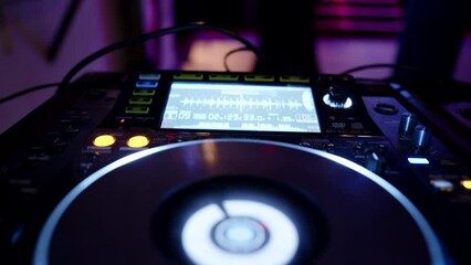 Lit buttons of a music mixing equipment for DJs in a club for a corporate party