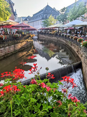 Main street with restaurants along the river of the tourist town of Saarburg in Germany