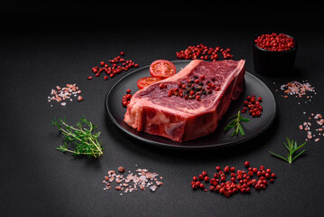 Fresh juicy raw new york beef steak with salt, spices and herbs