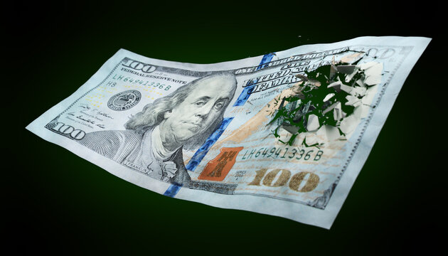 Broken US paper money on a green background