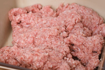 closeup minced meat, raw fresh minced meat with fat from pork, beef, lamb, concept of cooking at home in kitchen