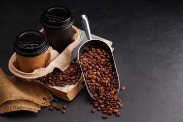 Rich coffee in a cup with aromatic roasted beans