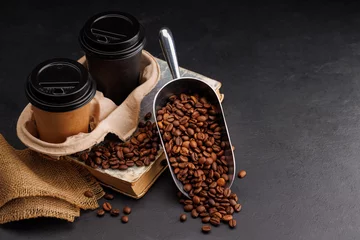 Rich coffee in a cup with aromatic roasted beans © karandaev