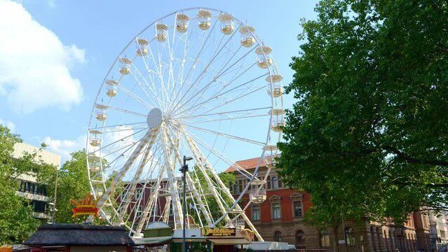 Braunschweig, Brunswick, Germany - June 09, 2023. Ferris wheel in the center of Braunschweig, summer city festival, summer entertainment in the city. 