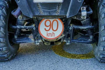 Red "90km h" sign attached to a blacquad bike