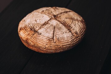 Closeup of a freshly baked bread put on the black table surface