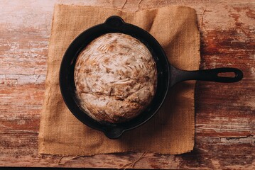 Top view of the freshly baked bread on the pan put on the wooden table surface