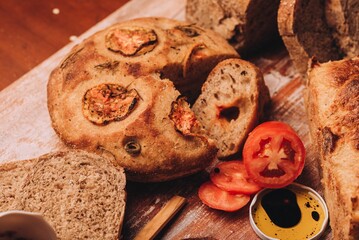 Closeup of freshly baked and sliced Italian bread put on the wooden table