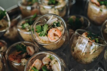 High-angle shot of a delicious meal in glass bowls with shrimp and coriander