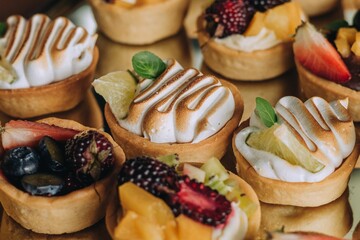 Assortment of delectable pastries with fresh fruit arranged atop a metallic serving tray