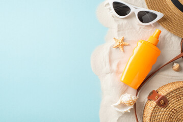 Embrace sun-safe vibe with top view sunscreen essentials: sunblock bottle, sunglasses, hat, shells, starfish, bag. They rest against pastel blue and sandy backdrop, offering space for label or advert
