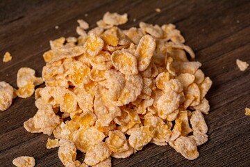 Close-up shot of a pile of cereal on a wooden table