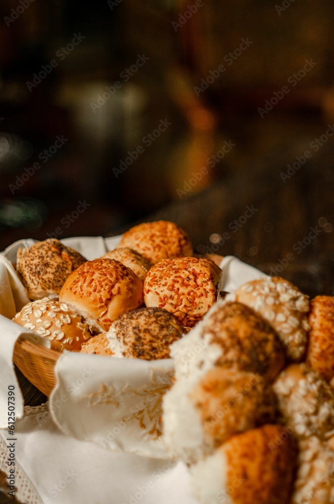 Poster Vertical shot of wheat bread with poppy seeds and cereal wrapped in towels