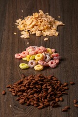 Fototapeta na wymiar Vertical shot of piles of cereals on a wooden table