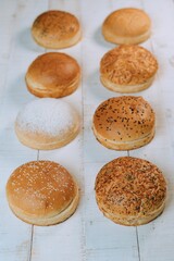 Vertical shot of the freshly baked bun bread put on the white table surface