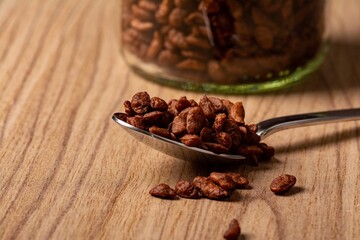 Jar of chocolate cereal on a wooden surface