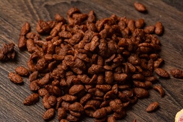 Close-up shot of a chocolate flavored pile of cereal on a wooden table