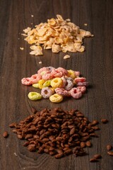 Types of breakfast cereal presented on a wooden surface