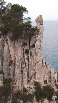 Vertical shot of a climber in the Calanque area in France on a big cliff