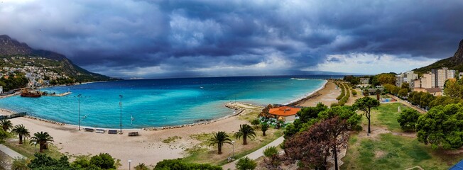 Panoramic shot of a coastline under a cloudy gloomy sky
