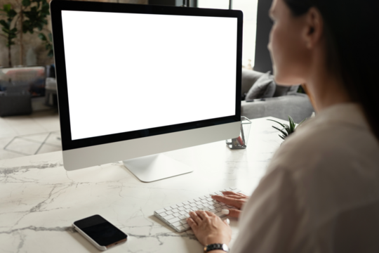 Attractive young woman working at office, using contemporary desktop computer, transparent screen