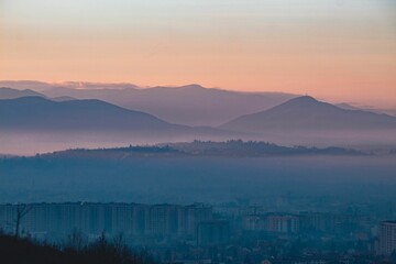 Landscape view of the mountains and hills against a blue sky in Sarajevo at sunset