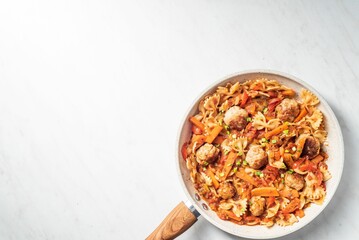 Top view of Spaghetti and meatballs dish with onion, red pepper, garlic and tomatoes with copyspace