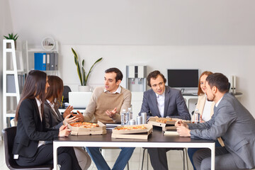 Group of business people with tasty pizza in office