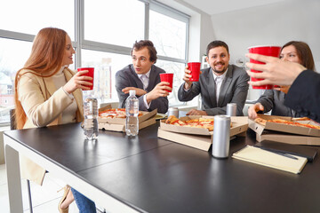 Group of business people with cola and tasty pizza in office