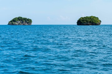 Scenic shot of two small rocky islands in the sea in the 1000 Islands national park in Philippines