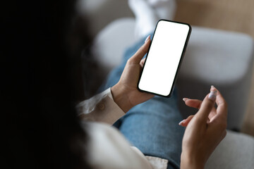 Young woman user customer hold smartphone mock up transparent screen in hand use mobile shopping app, check social media news