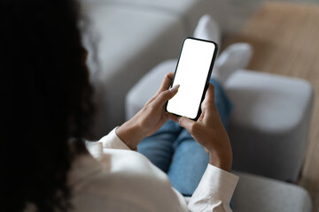 Young woman user customer hold smartphone mock up transparent screen in hand use mobile shopping app, check social media news