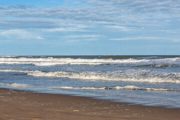 Fototapeta na wymiar panoramic view of sandy beach with waves